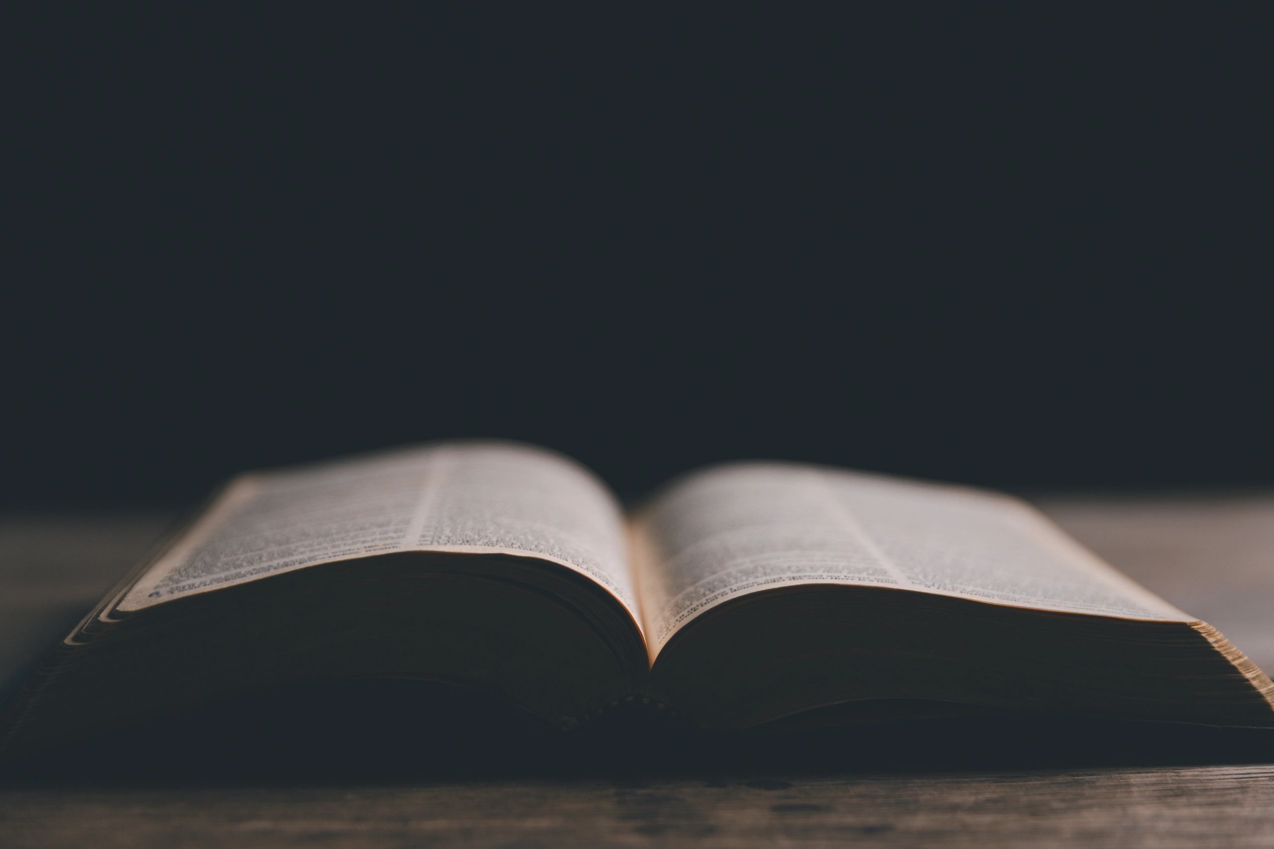 Open Bible and cross in warm light